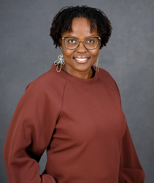 Angela Patton, smiling Black woman looking at camera, wearing glasses