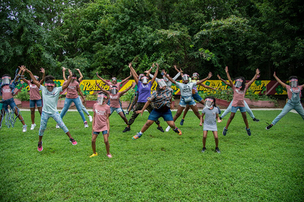 Field of girls outside jumping up