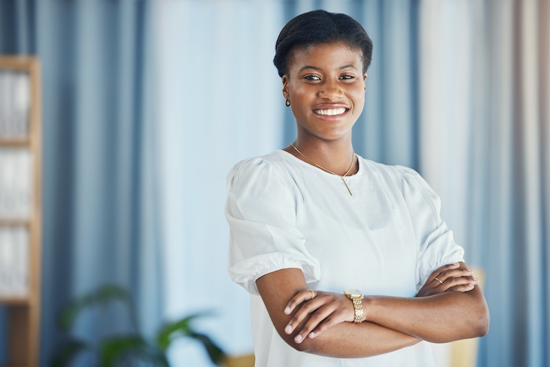 Lawyer, portrait and black woman in office with arms crossed in confidence for justice, law firm and legal career. Attorney, smile or face of employee with pride in workplace or human rights advocate Lawyer, portrait and black woman in office with arms crossed in confidence for justice, law firm and legal career. Attorney, smile or face of employee with pride in workplace or human rights advocate.