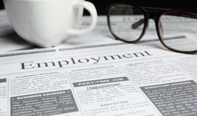 Cup and glasses on newspaper. Search concept