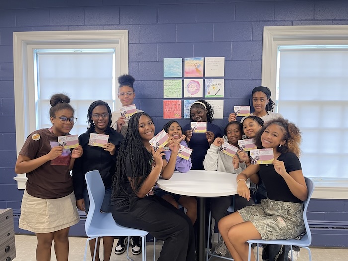 Girls holding GAP postcards